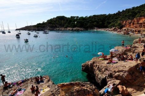 Boat rental in Ibiza anchored in the bay of Cala Salada and Cala Saladeta