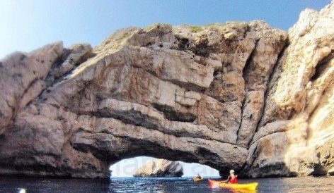 Exploring the tunnel of the Ses Margalides islands of Ibiza by kayak