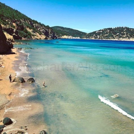 Waves and clear waters at Aguas Blancas beach in Ibiza