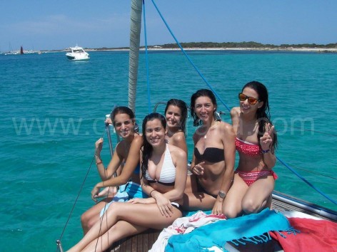 girls at the front of the sailing boat in ibiza