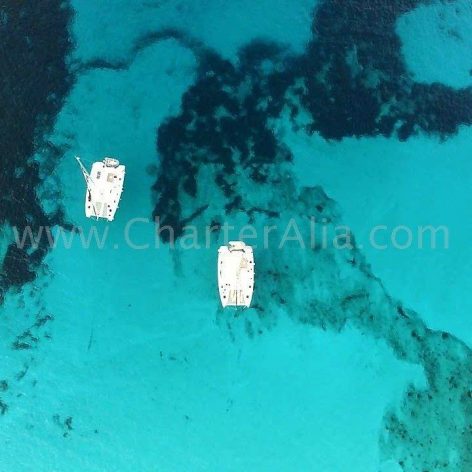 Aerial view of catamaran Lagoon 380 2018 rental boats in Ibiza in Cala Comte