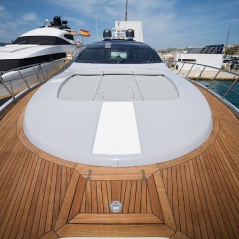 Front view of the imposing Mangusta 92 yacht with wooden details and rest area