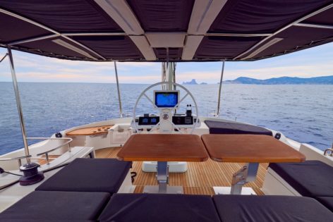 The upper deck of the Lagoon 52 catamaran with the helm also has a table