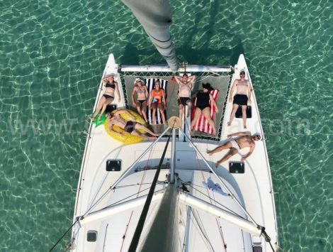 Vista aerea do catamara da lagoa 380 da parte superior da vara com os clientes que apreciam as redes da curva
